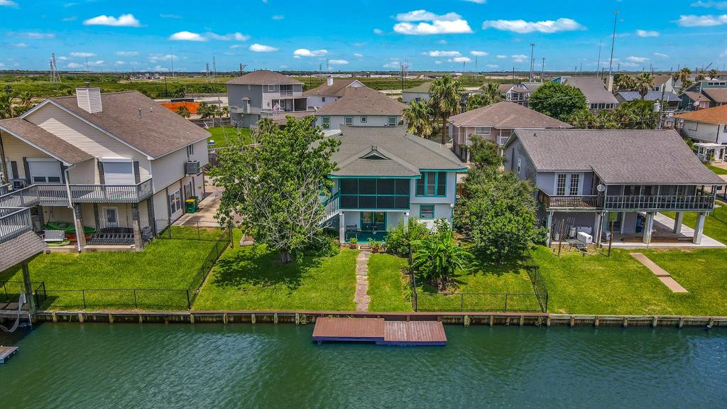 an aerial view of a house with a garden and lake view