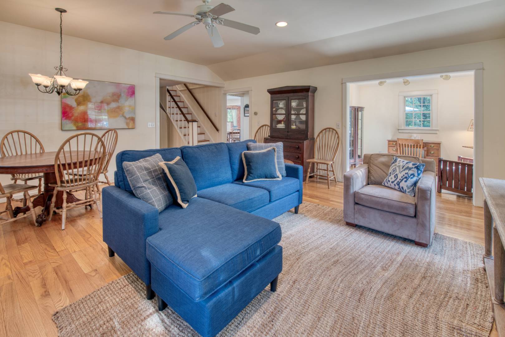 a living room with furniture and wooden floor