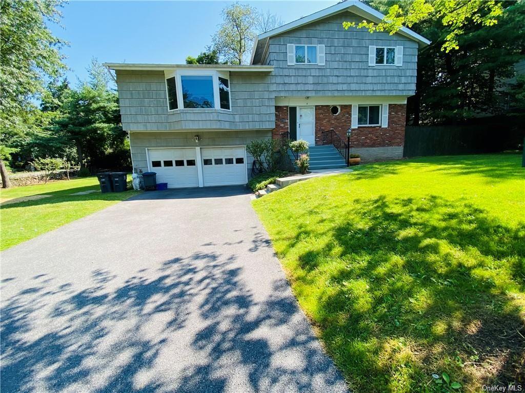 a view of a house with swimming pool next to a yard