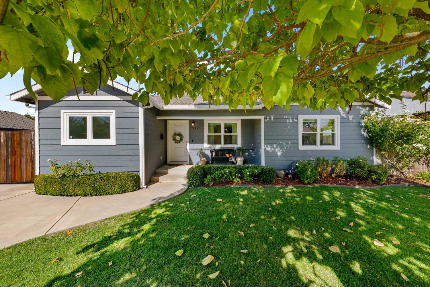 a front view of house with yard and green space