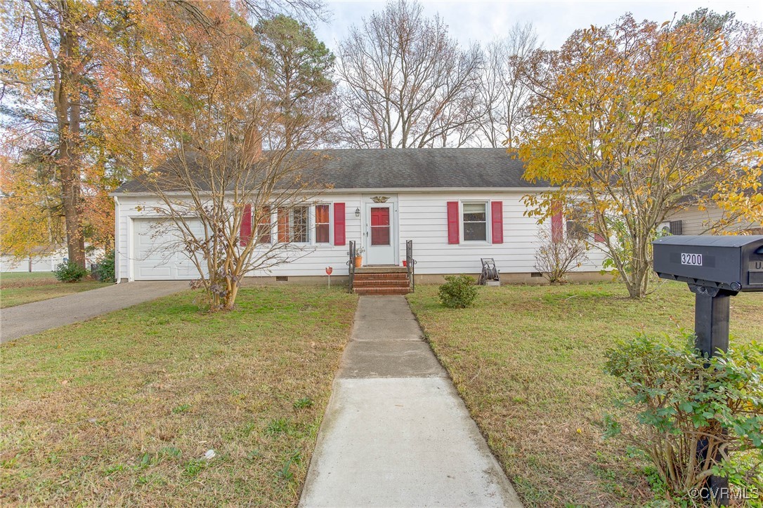 Ranch-style home with a front lawn and a garage