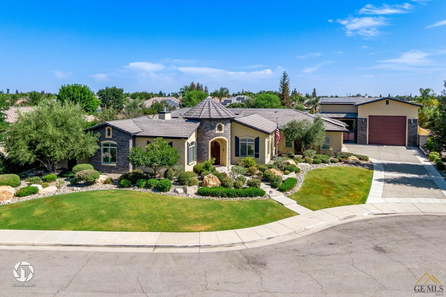 a front view of a house with a garden and a yard