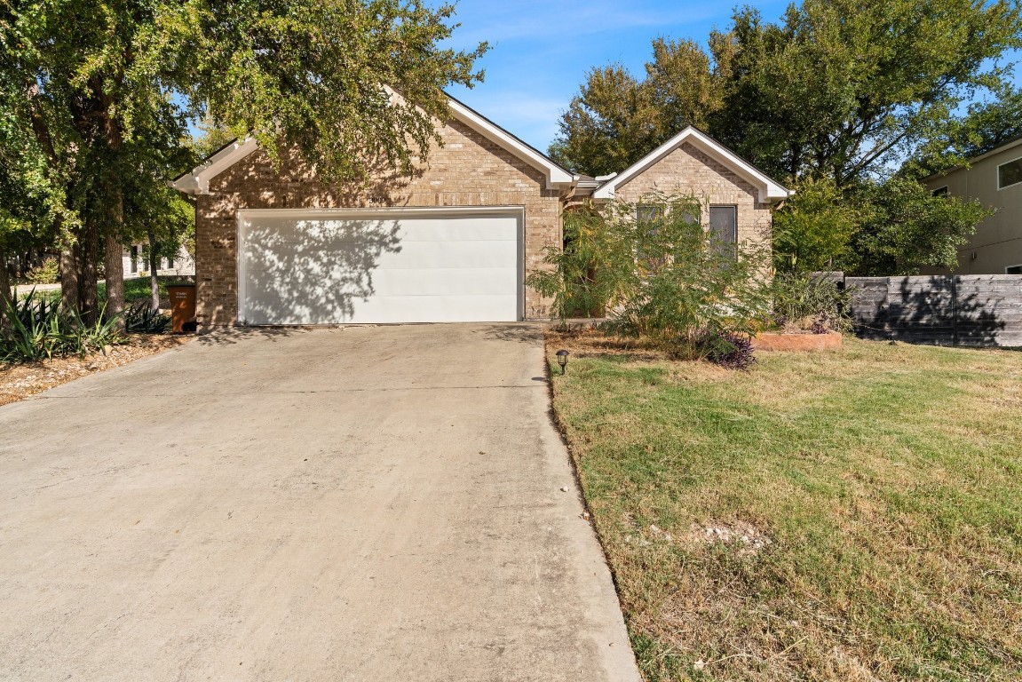 a view of a house with a yard and garage