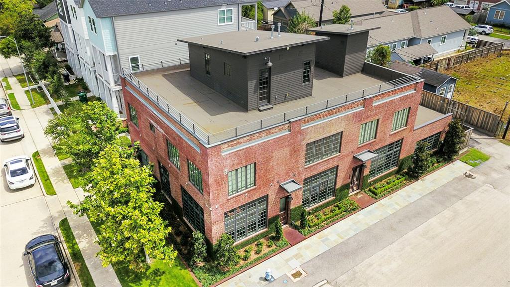 an aerial view of a house with a yard