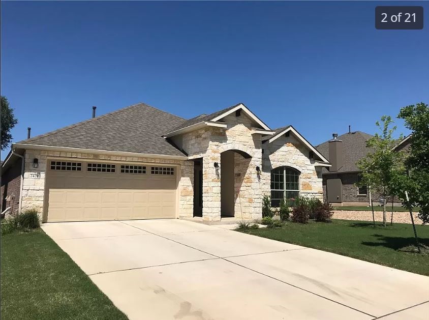 a front view of a house with a yard