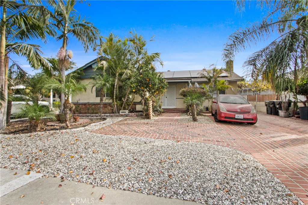 a couple of cars parked in front of a house