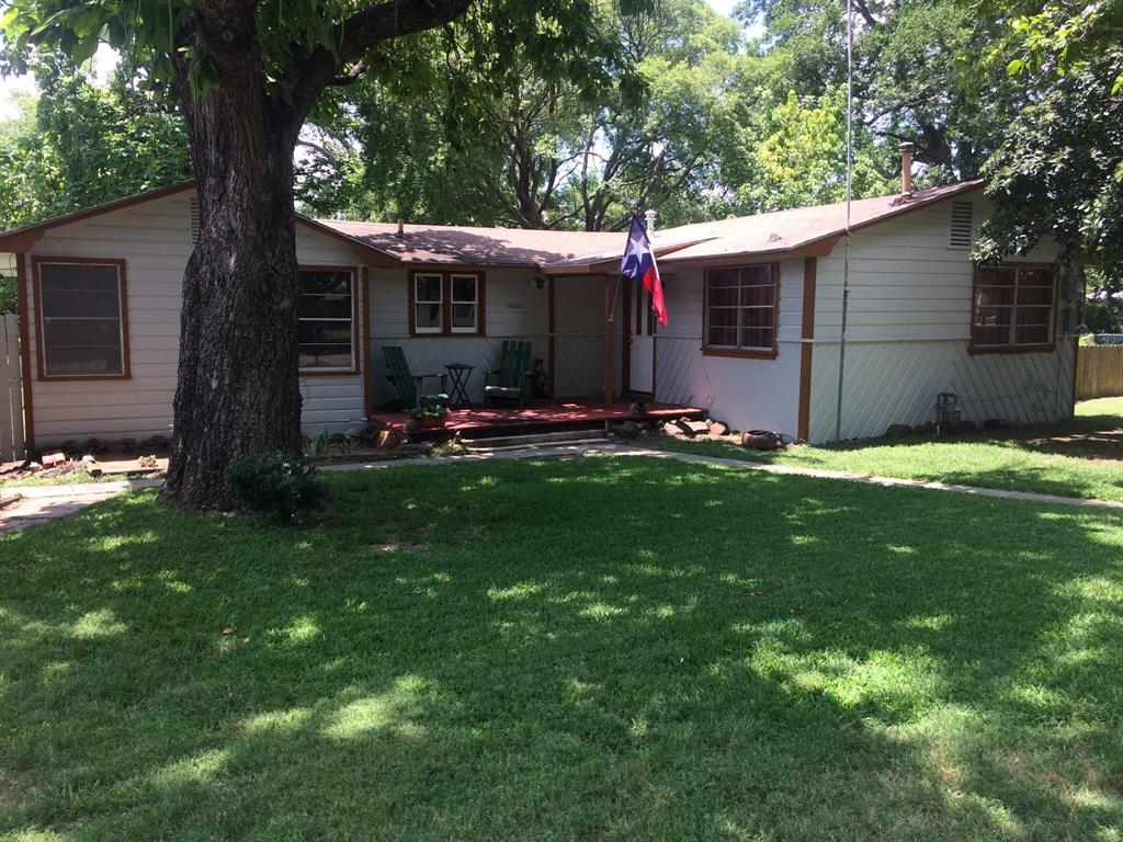 a view of a house with a yard and sitting area