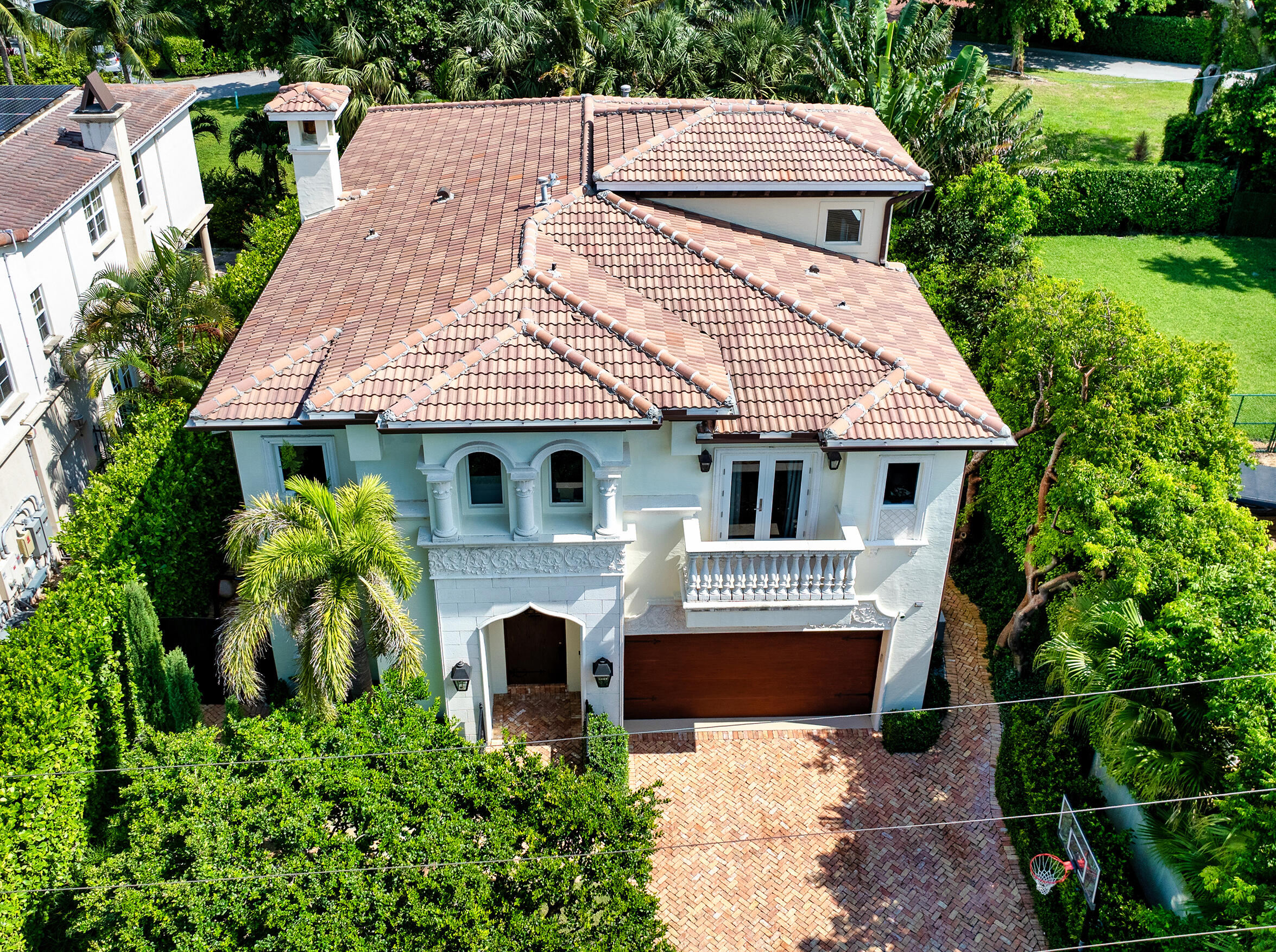 an aerial view of a house with a yard and potted plants