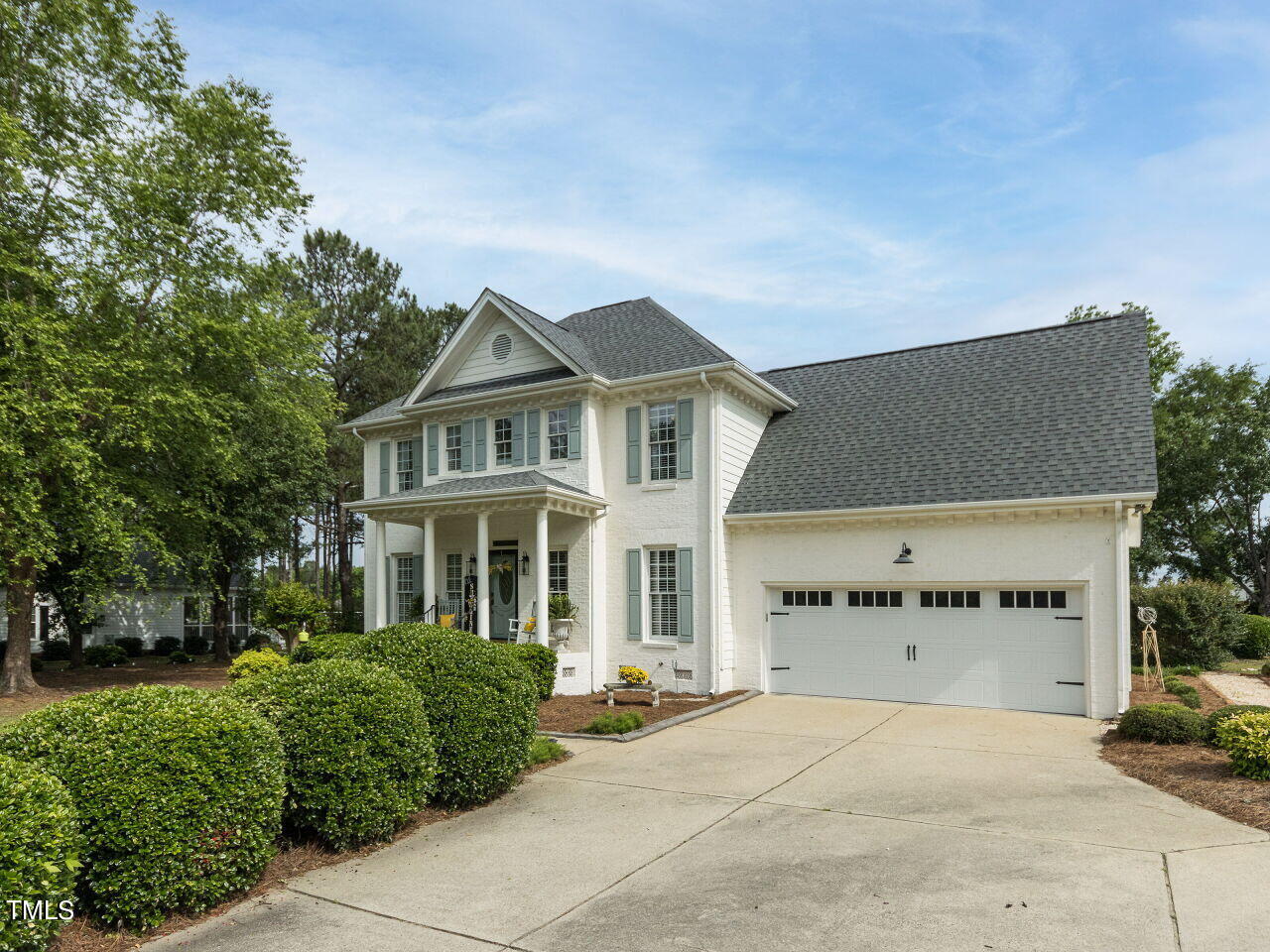 front view of a house with a garden