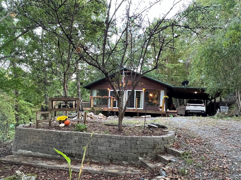 a front view of a house with yard and sitting area