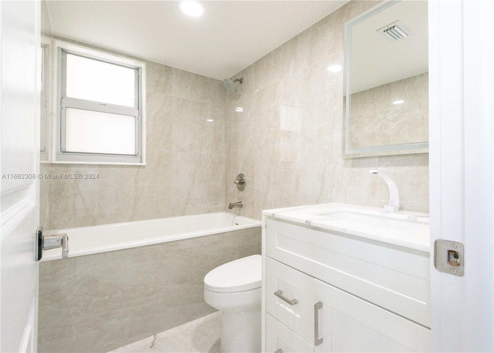 a bathroom with a sink a toilet and a bathtub