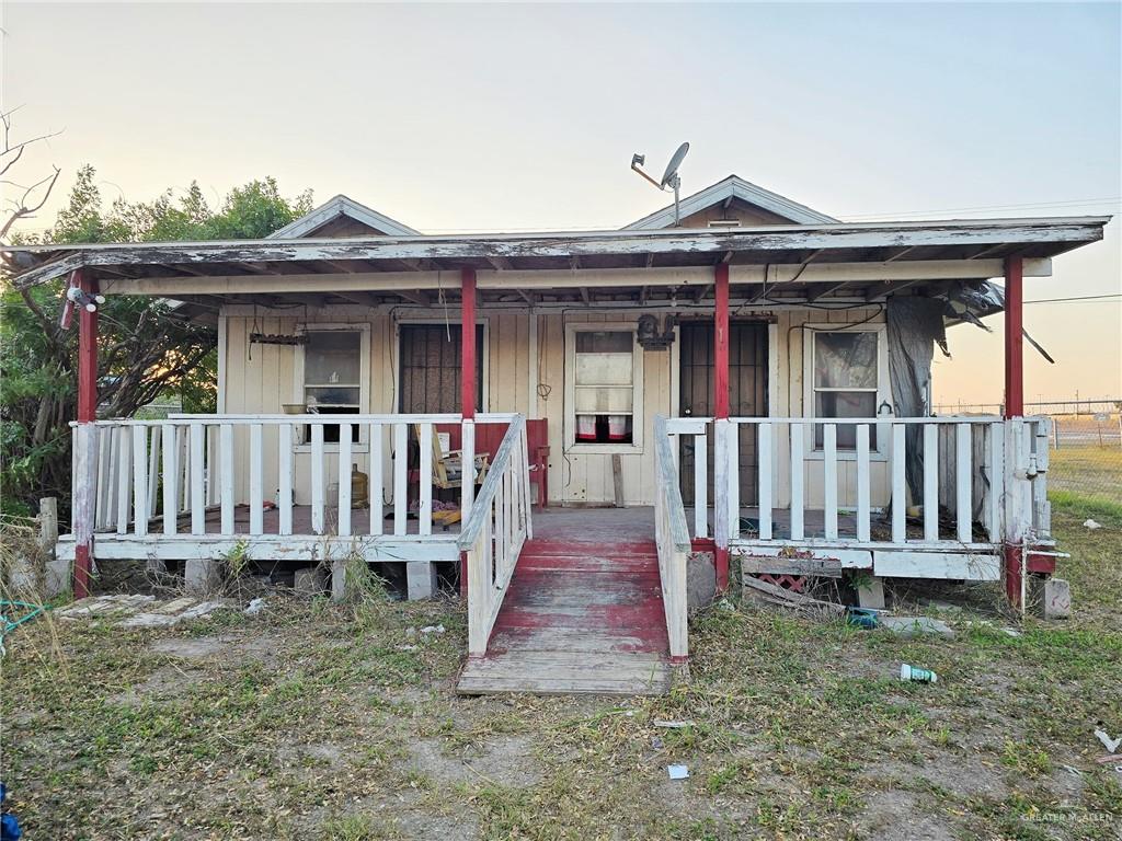 a front view of a house with wooden deck