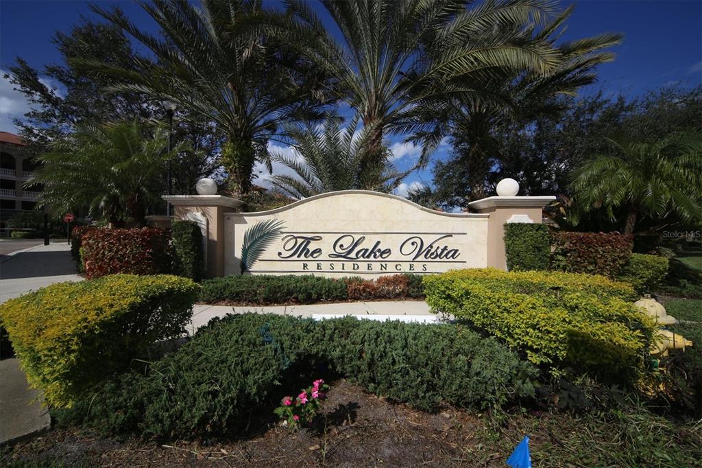 a view of a sign in a yard with plants