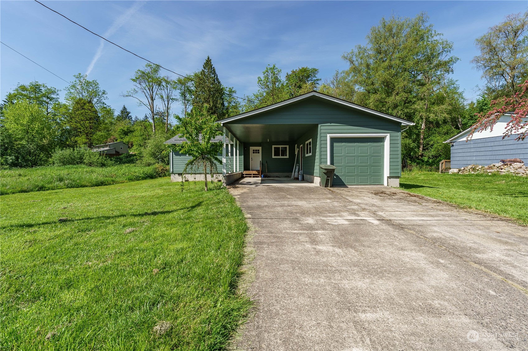 a view of a house with yard and a garden