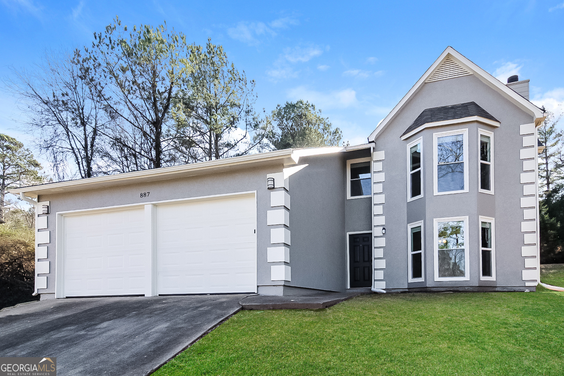 a front view of a house with a yard