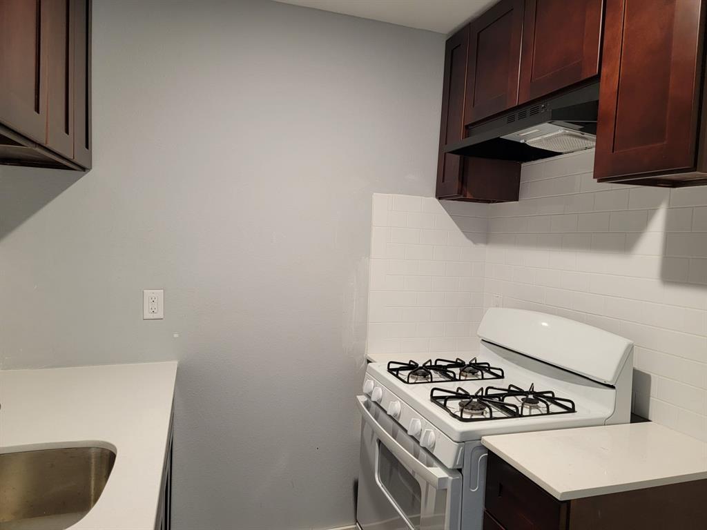 a kitchen with a stove and a cabinets