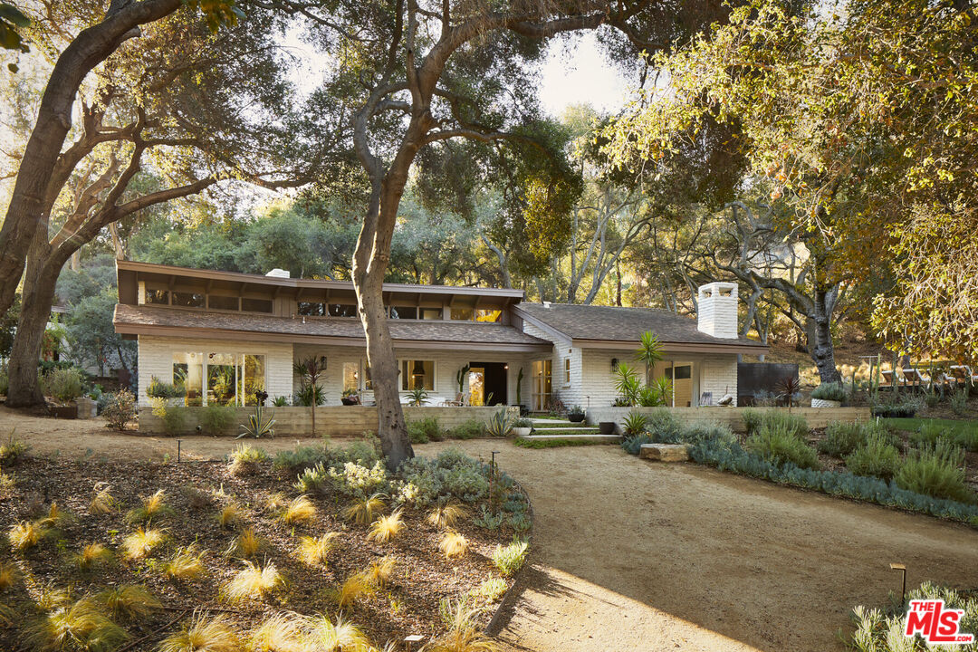 a front view of a building with trees