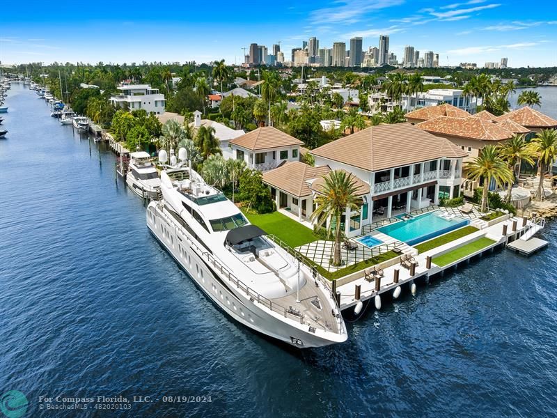 an aerial view of a house with wooden floor a city view