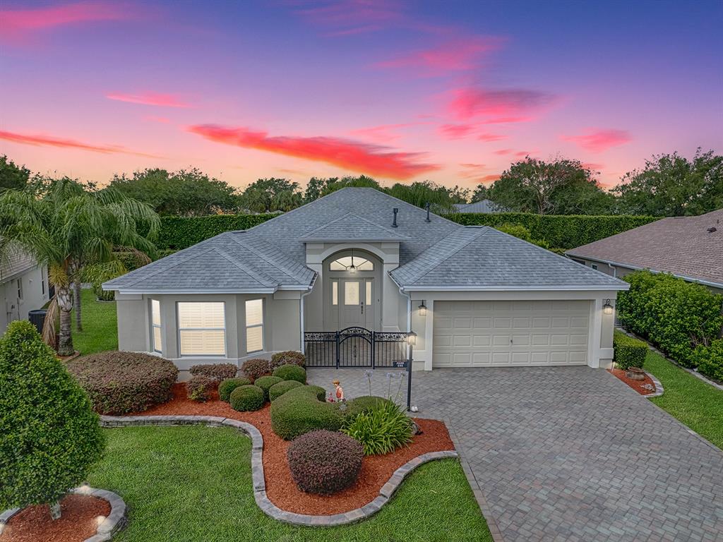 a front view of a house with a yard and garage