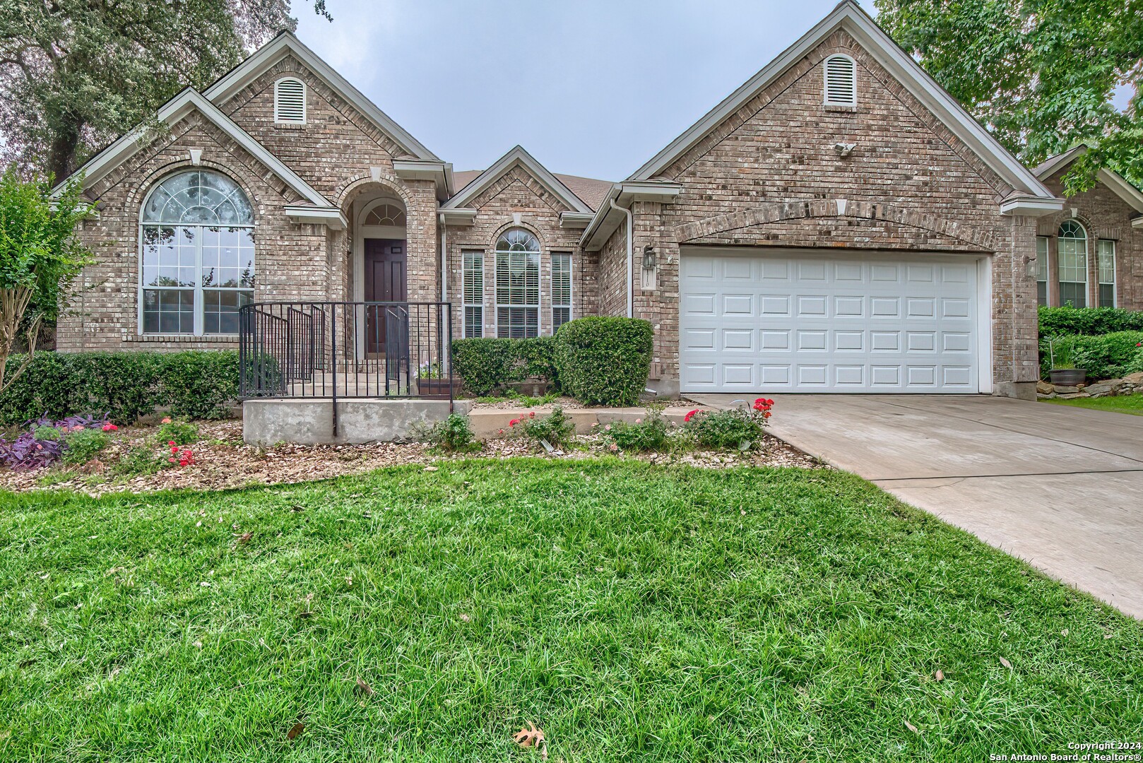 a front view of a house with a yard and garage