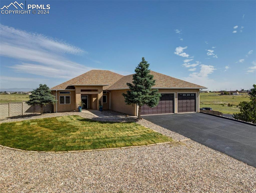 a front view of a house with a yard