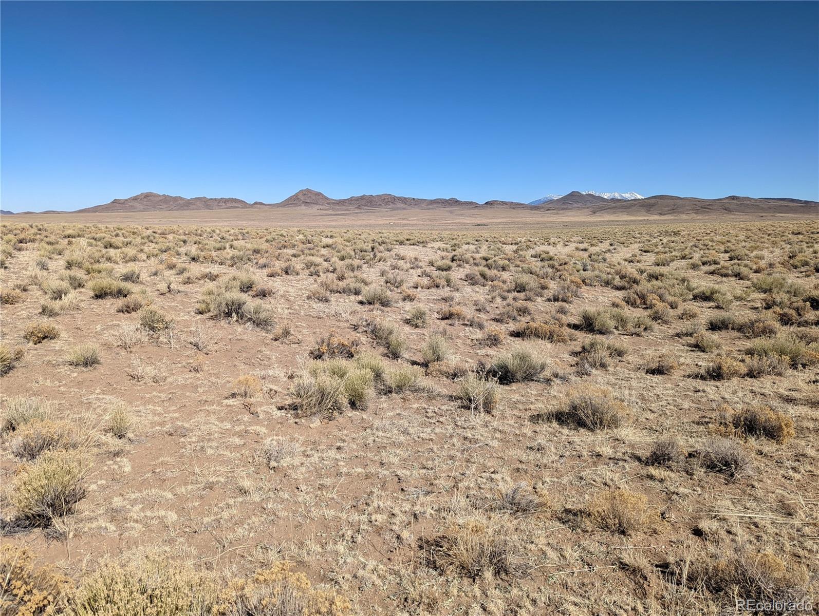 a view of a large mountain with mountains in the background