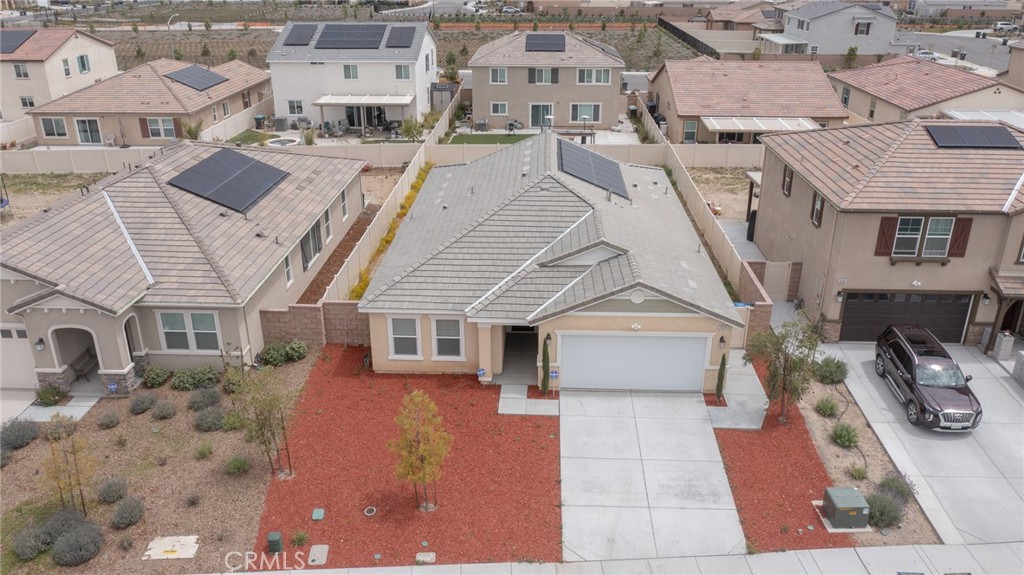 an aerial view of a house with a yard and potted plants