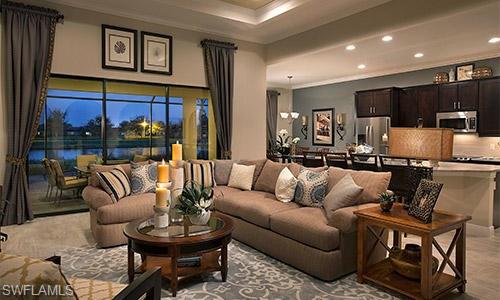 a living room with furniture kitchen view and a large window