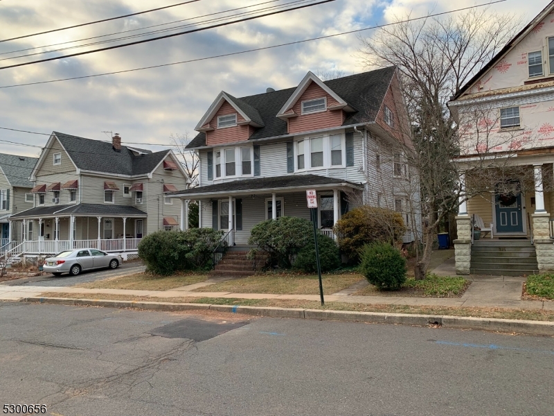 a front view of a residential apartment building with a yard