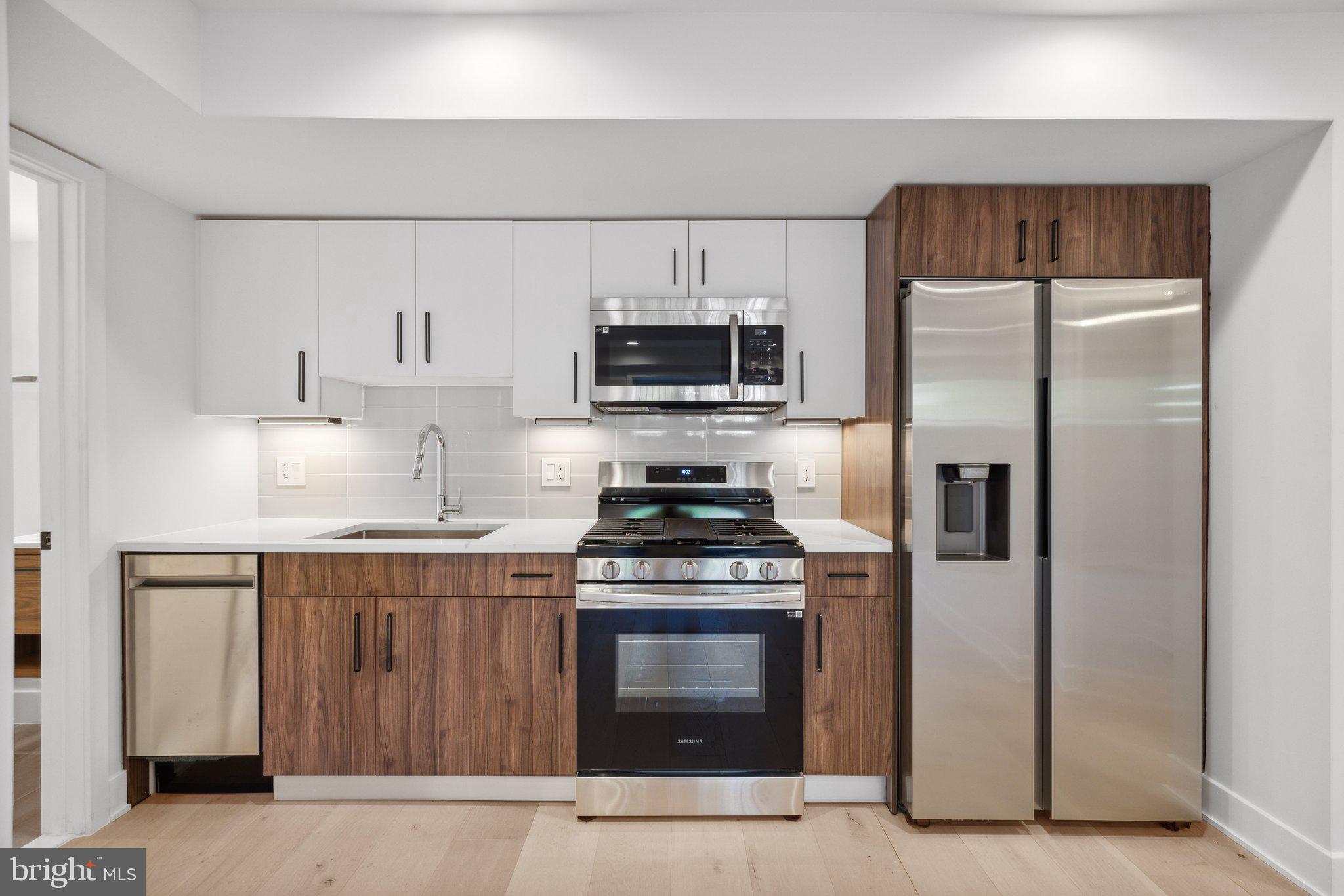 a kitchen with refrigerator a stove and cabinets