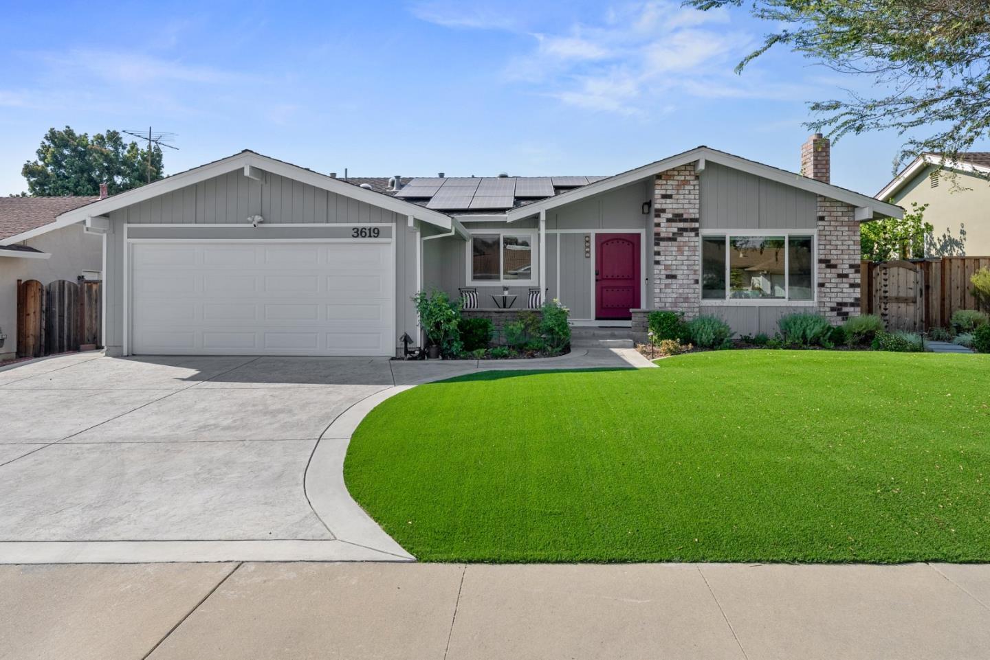 a aerial view of a house with a yard and garage