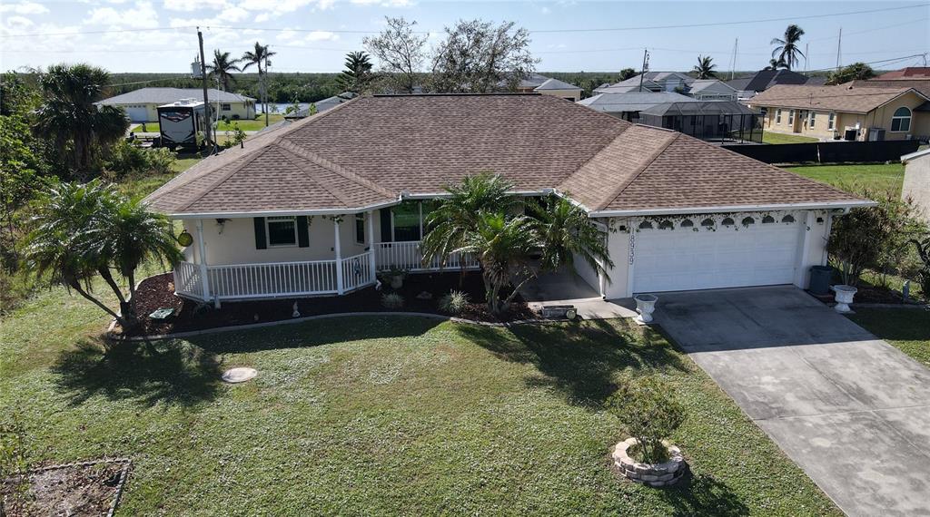 a aerial view of a house with a yard and potted plants