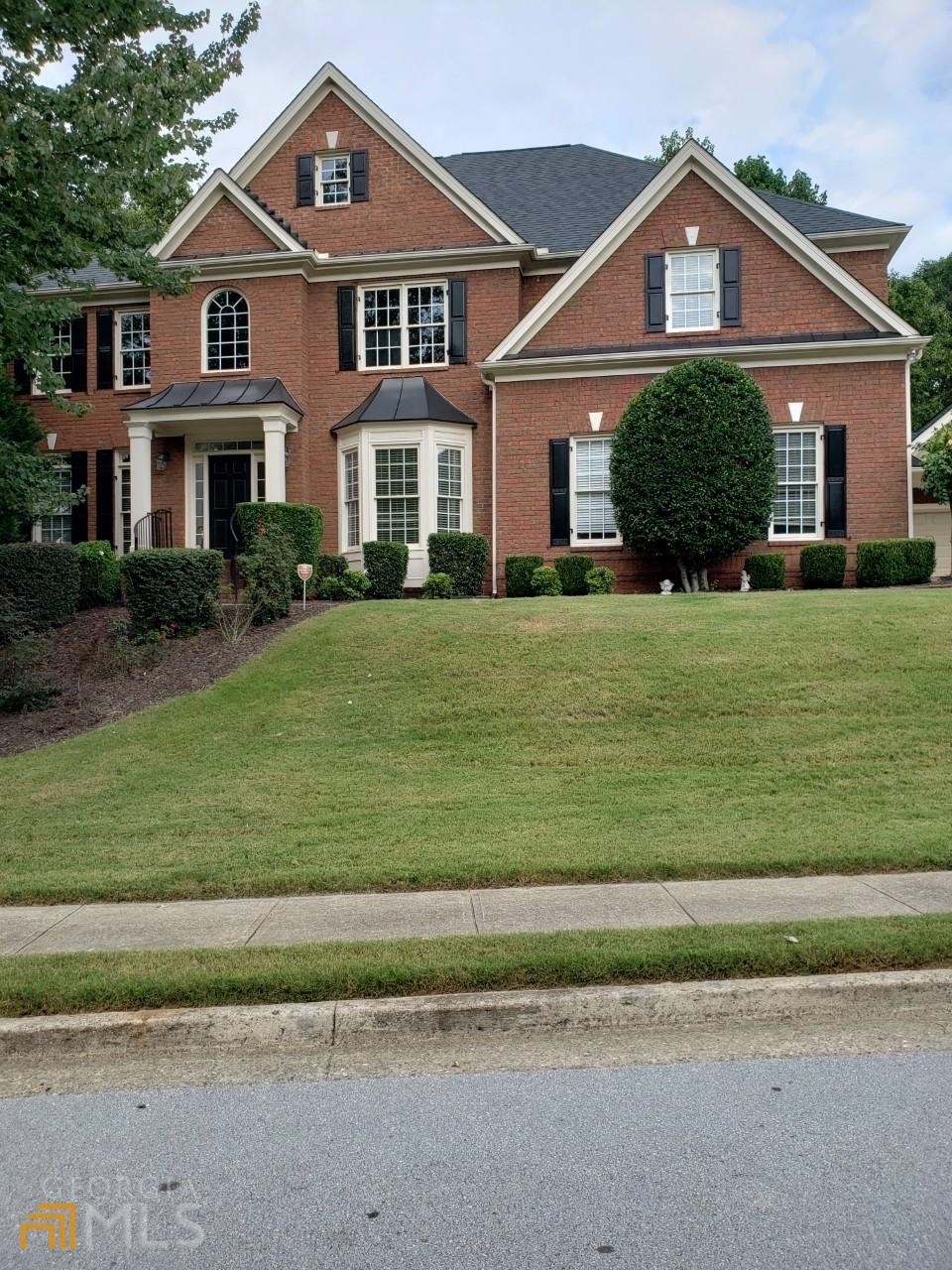 a front view of a house with a yard