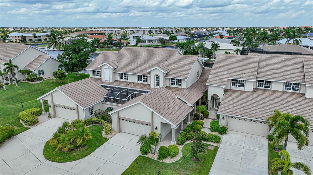 an aerial view of multiple houses with a yard