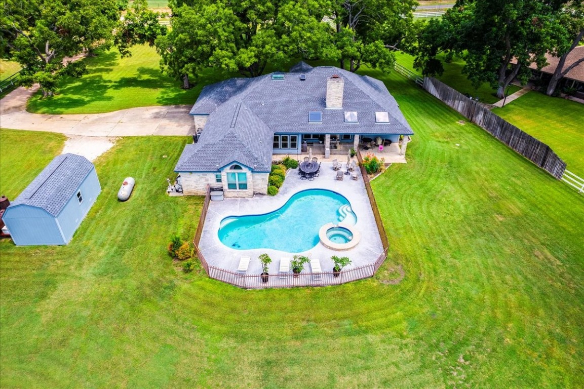 Aerial view of the backyard featuring pool, hot tub, Kool-deck patio and additional covered patio!