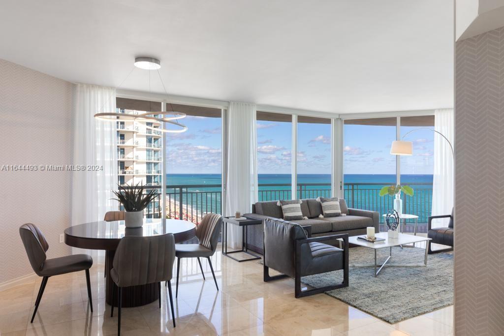 a living room with furniture and a floor to ceiling window