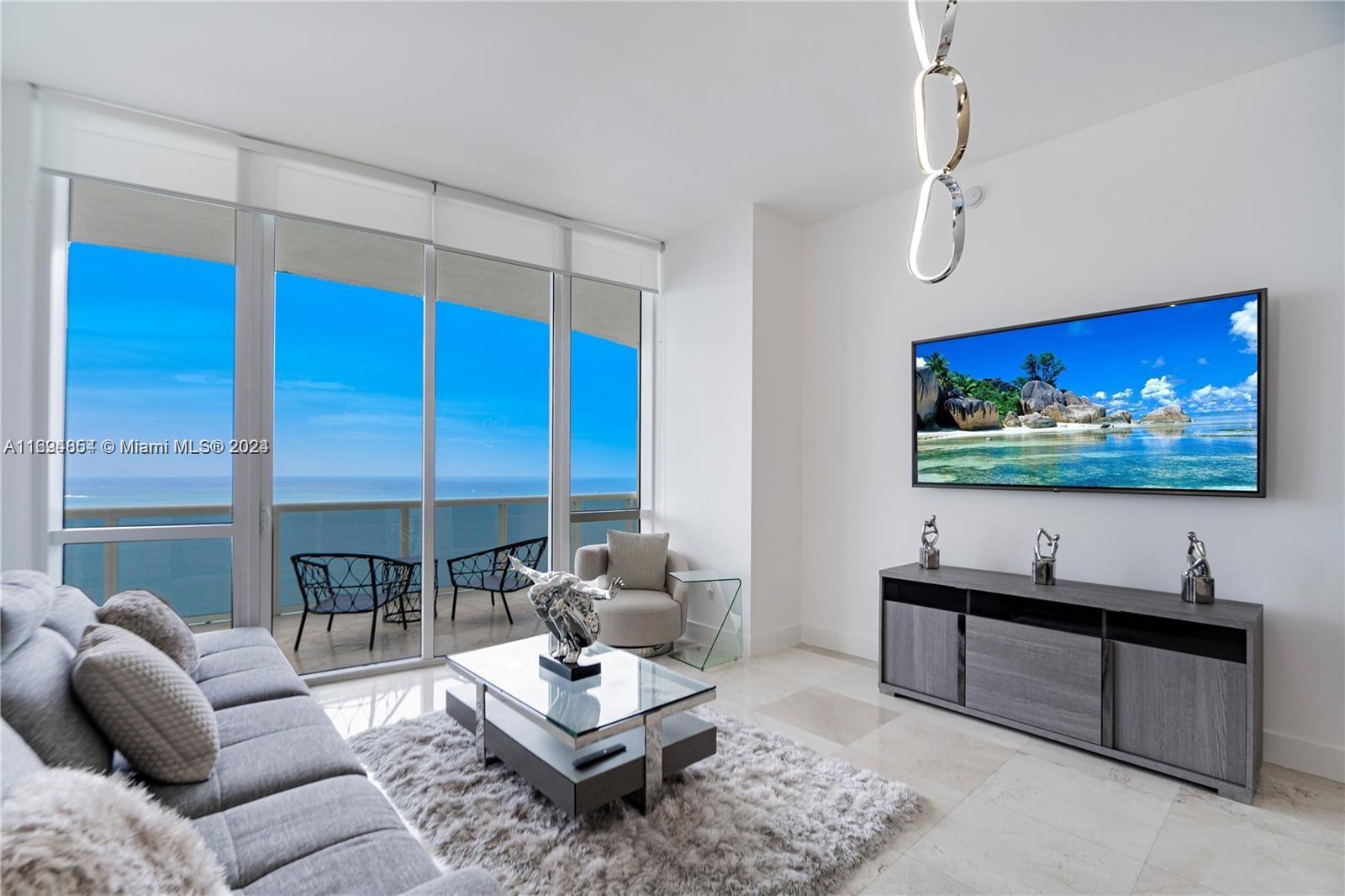 a living room with furniture a rug and a flat screen tv