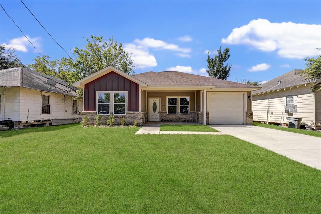 a front view of a house with a garden