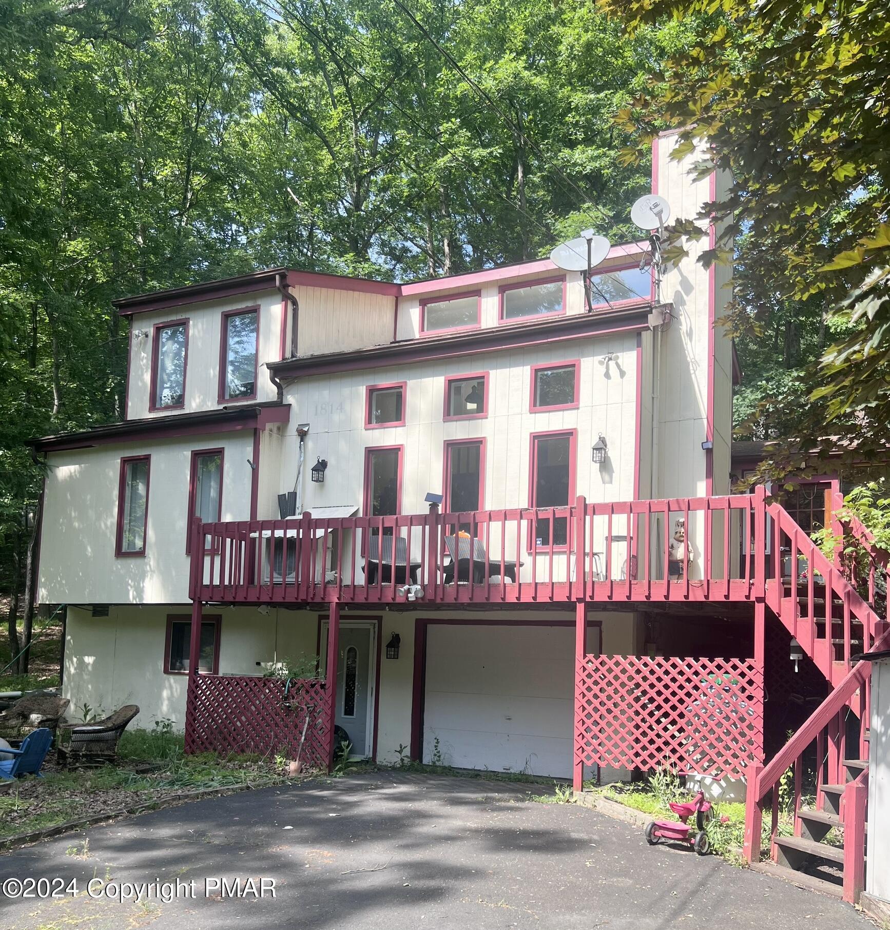 a front view of a house with outdoor seating