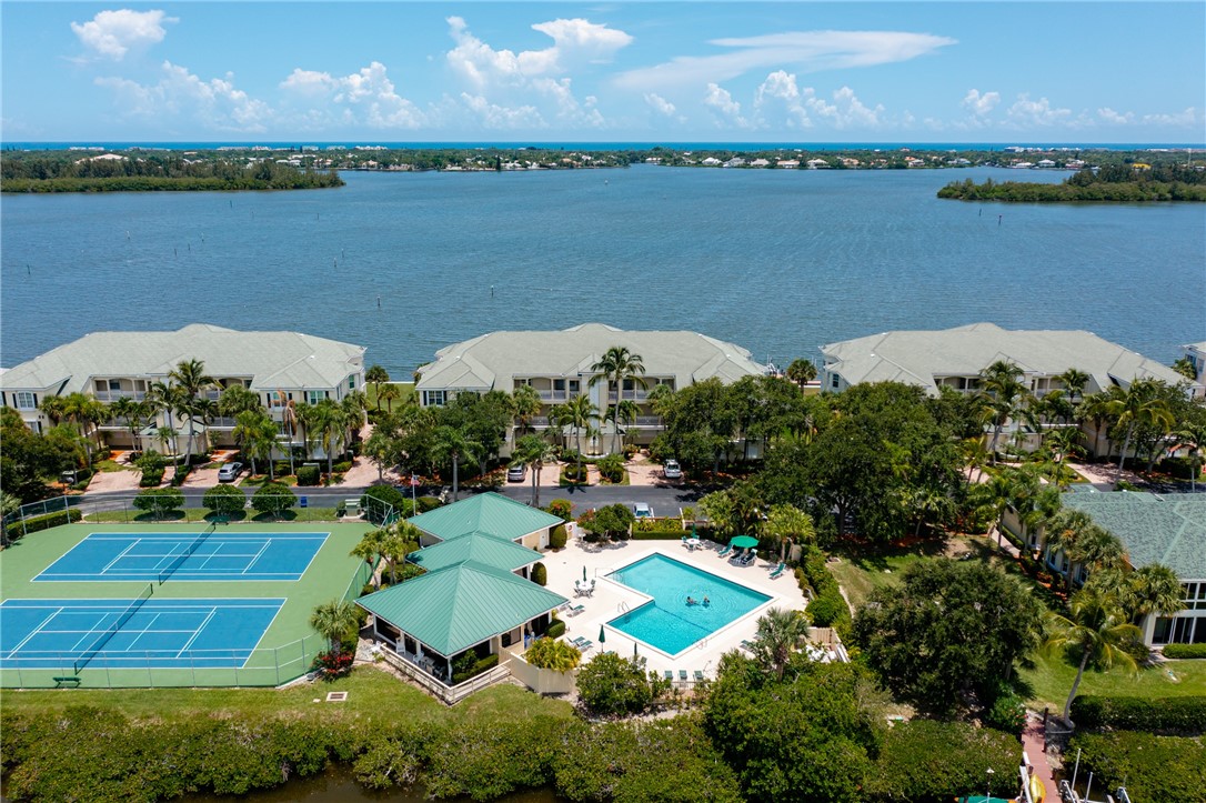 an aerial view of a houses with outdoor space and lake view