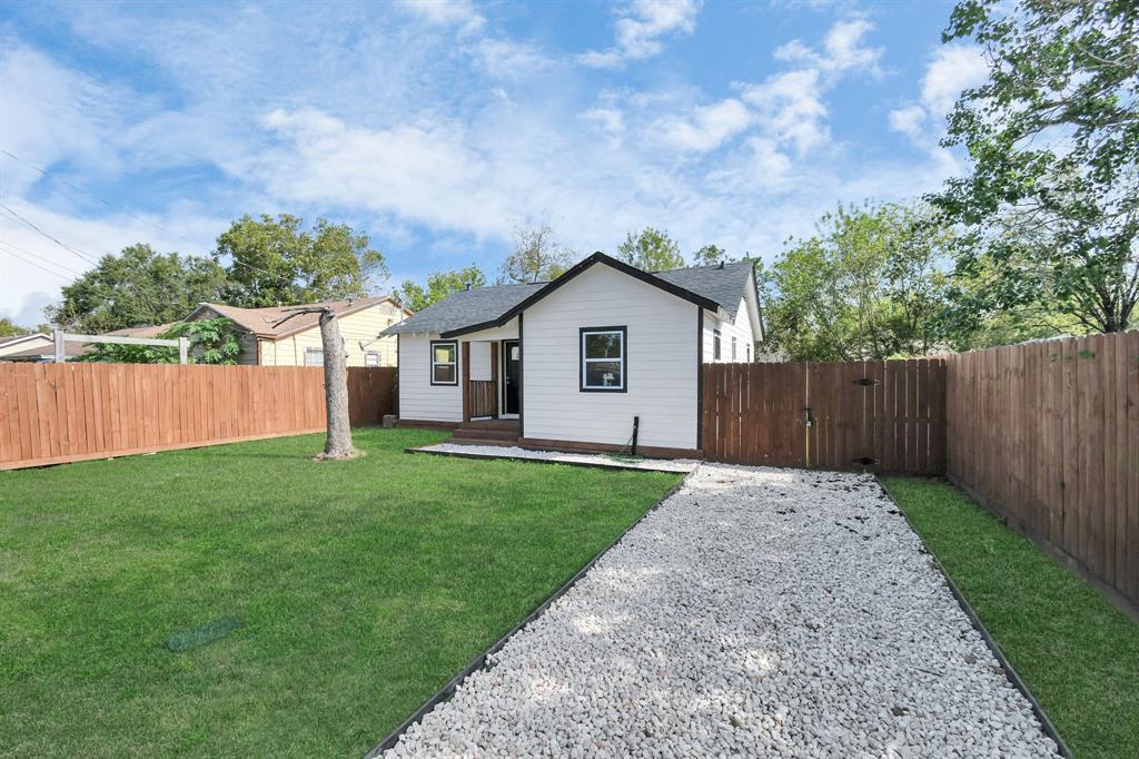 a view of backyard of house with green space