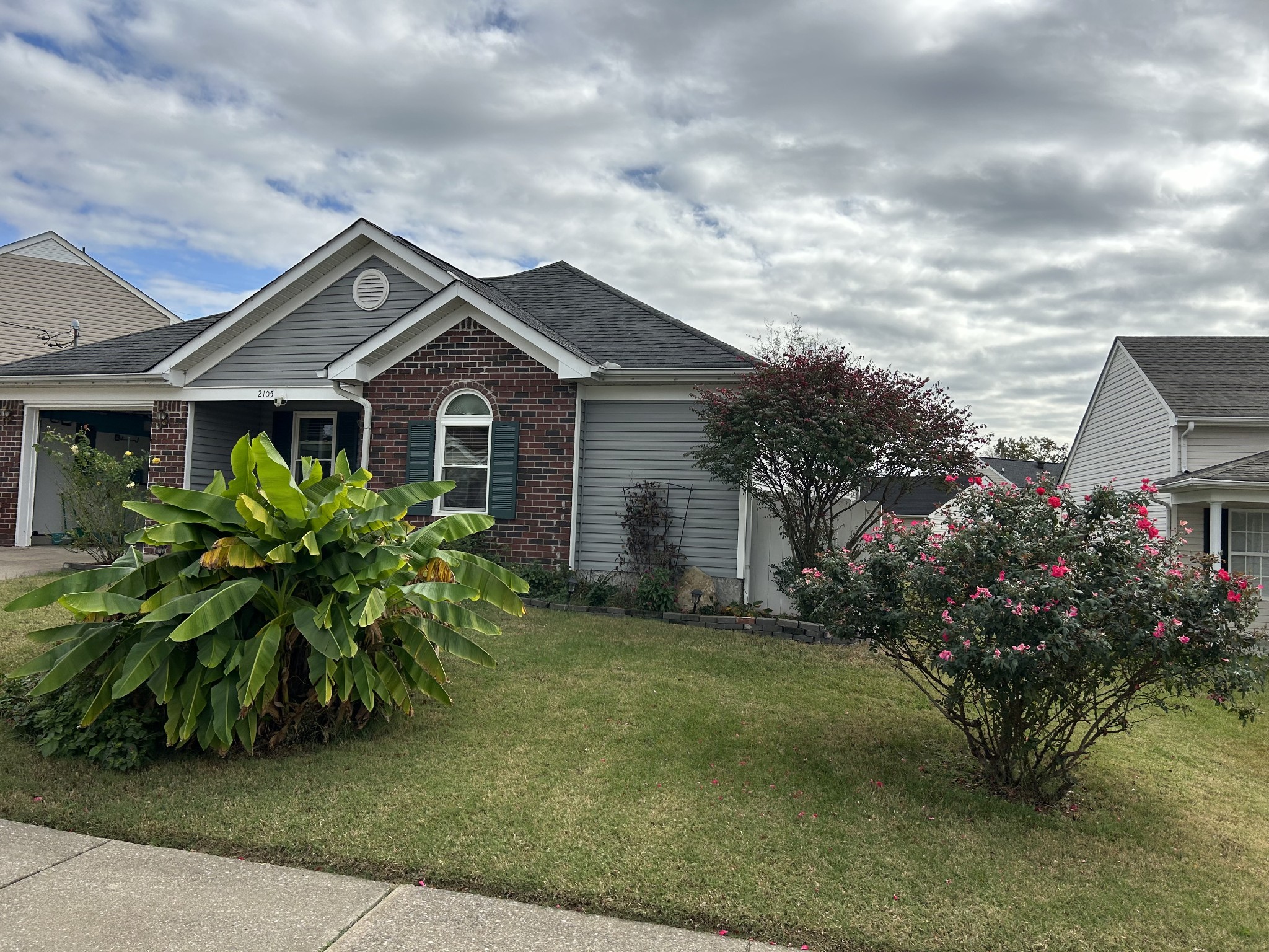 a front view of house with yard and green space