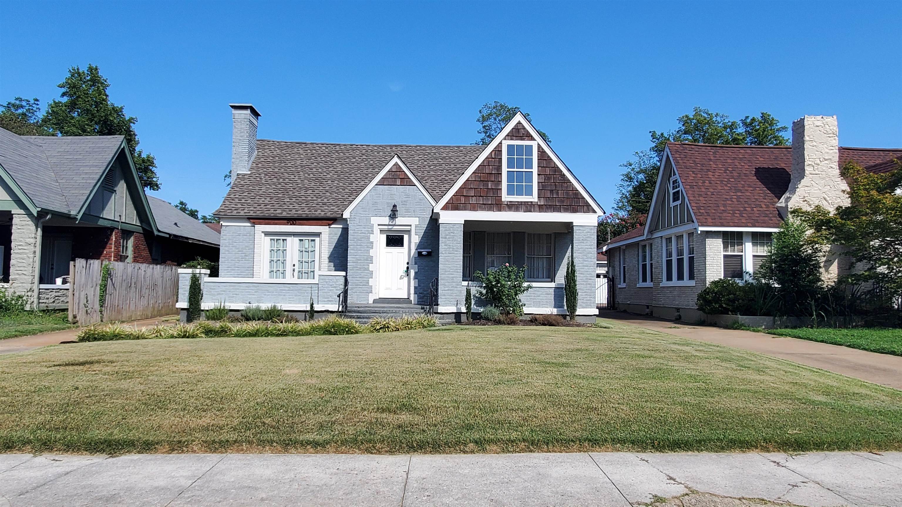 a front view of a house with a garden