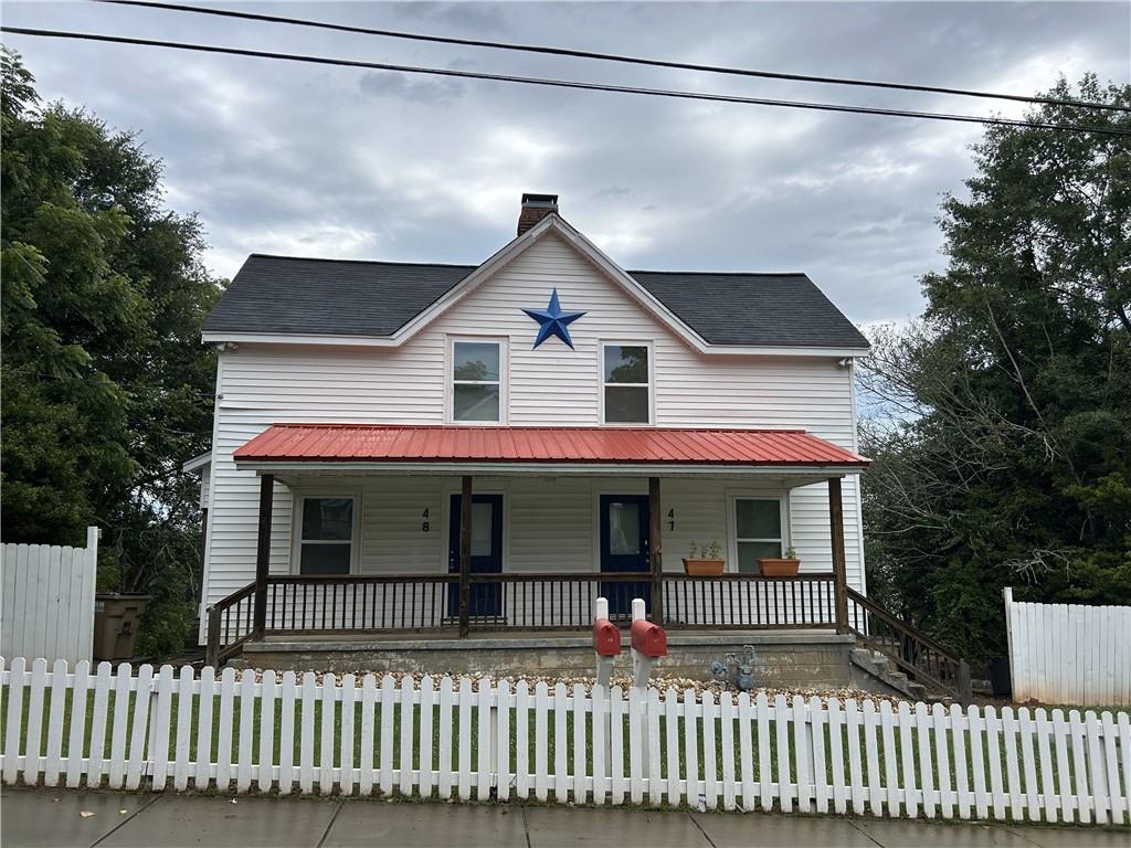 a front view of a house with a porch