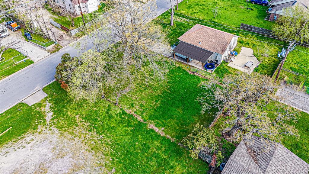 an aerial view of a house with garden space and street view