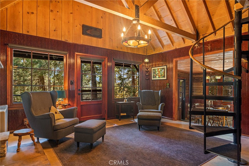 a outdoor living room with furniture and a floor to ceiling window