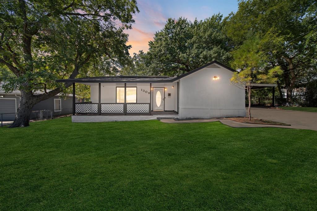 a front view of house with yard and green space