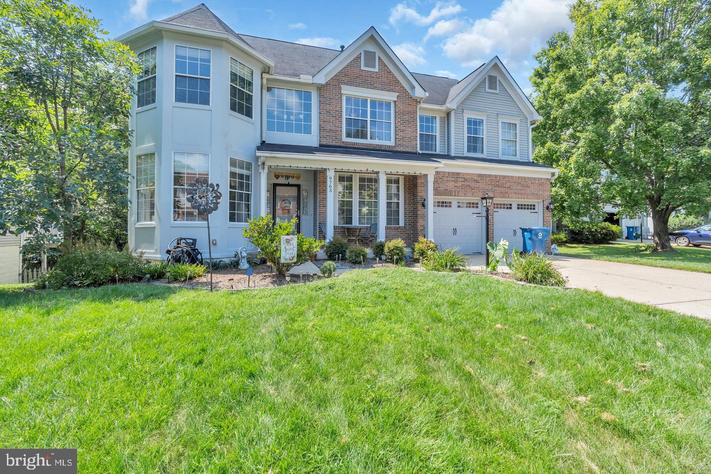 a front view of a house with a yard and porch