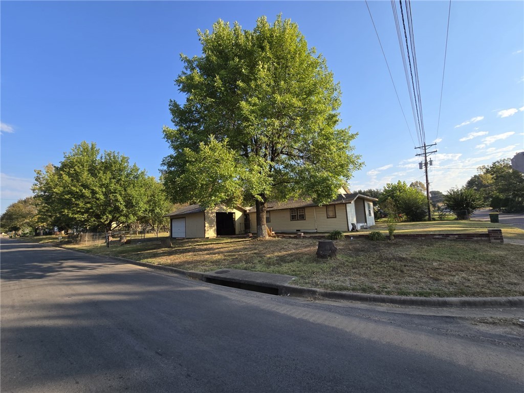 a view of a house with a yard and garage