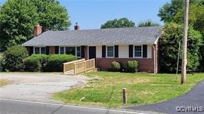 a view of a house with a yard and potted plants